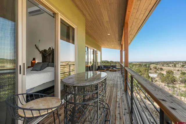 a balcony with table and chairs