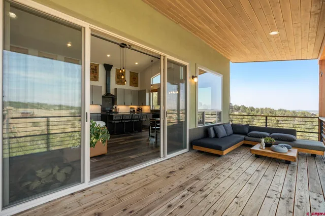 a living room with furniture stove and wooden floor