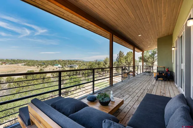 a view of a balcony with chair and wooden floor