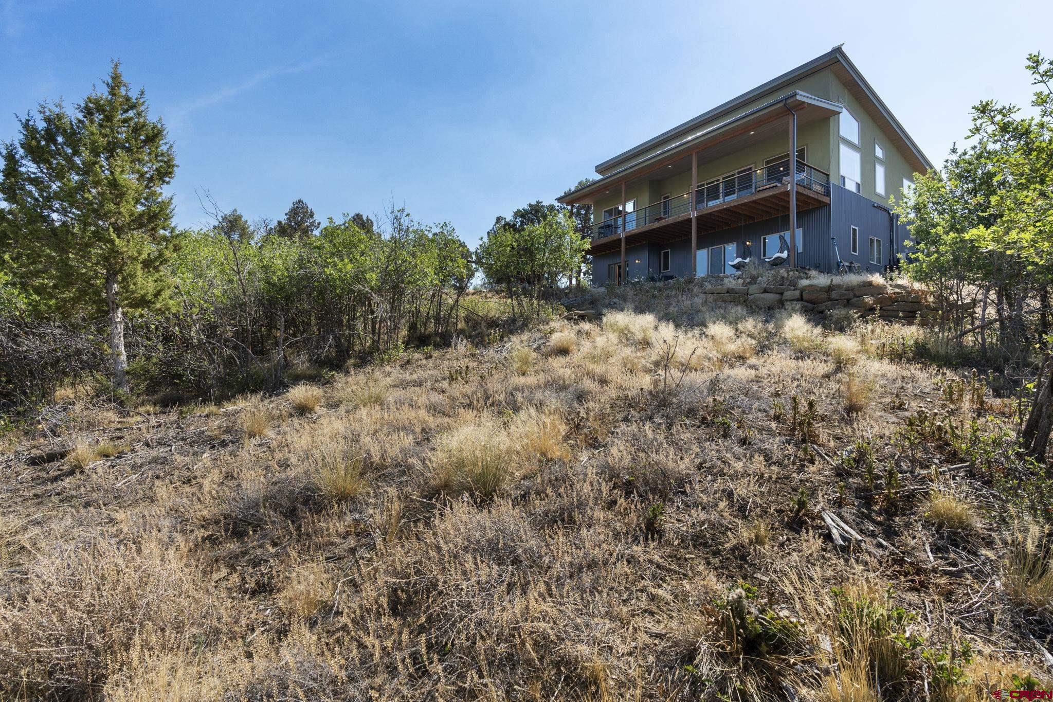 68 Cody Road Durango, CO 81303 - Photo 38 of 45 a view of a house with a yard and wooden fence