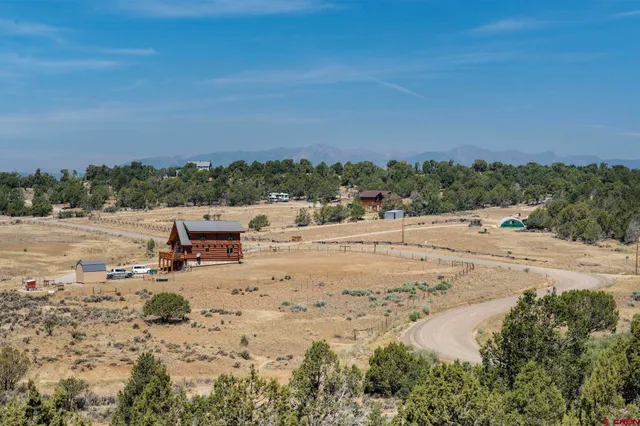 a view of a chair and table in backyard