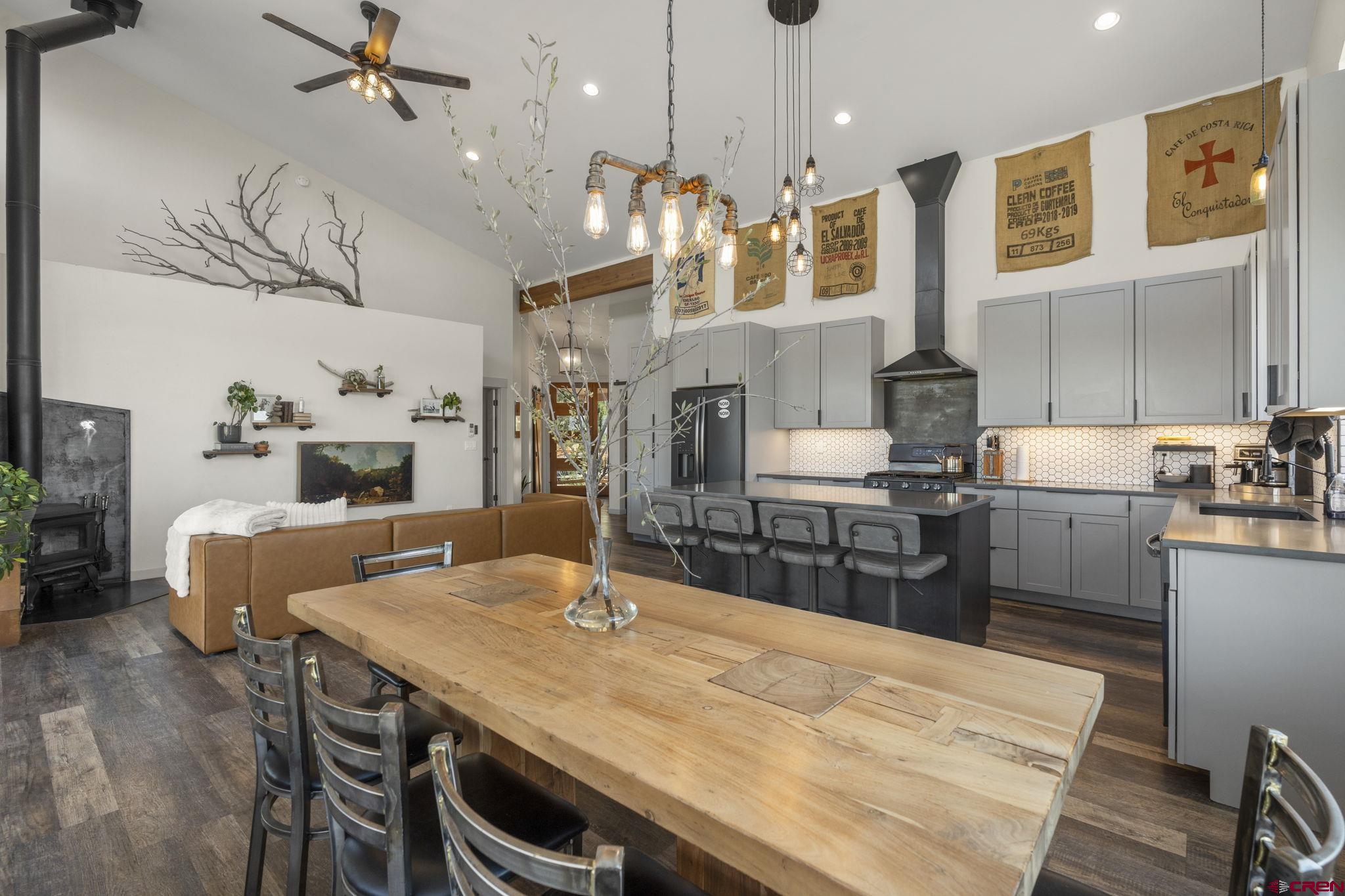 68 Cody Road Durango, CO 81303 - Photo 8 of 45 a kitchen with stainless steel appliances kitchen island a table chairs in it and wooden floors
