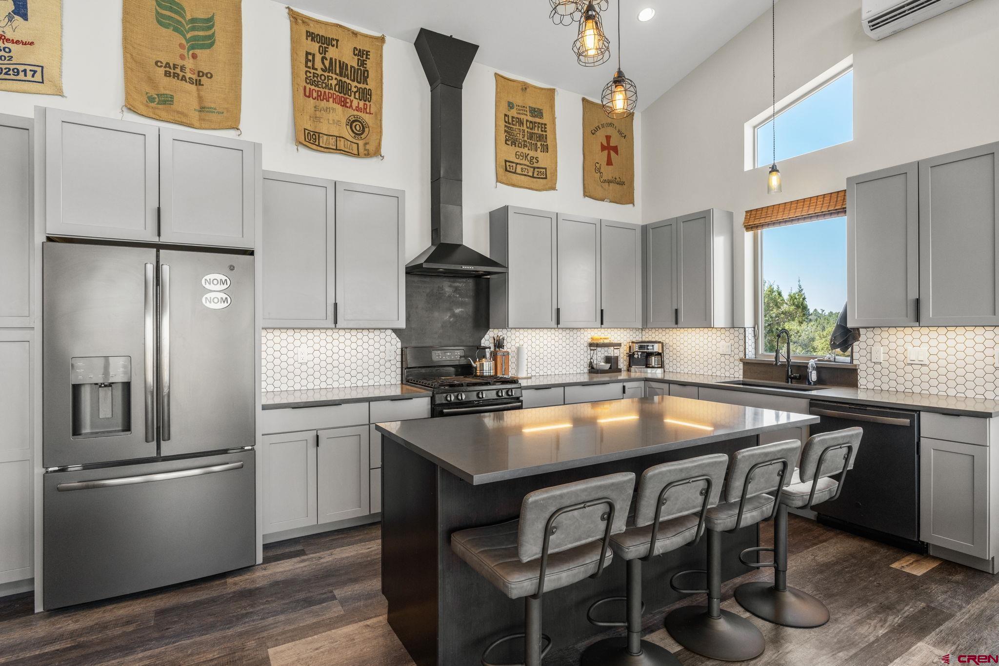 68 Cody Road Durango, CO 81303 - Photo 9 of 45 a kitchen with stainless steel appliances granite countertop a table chairs stove and refrigerator