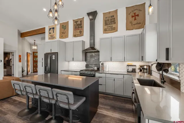 a kitchen with stainless steel appliances granite countertop a stove refrigerator and cabinets