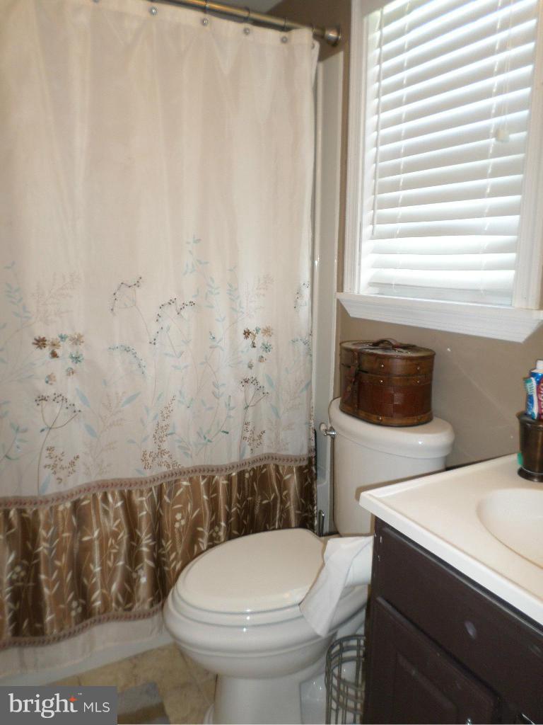 2520 Neudecker Road Westminster, MD 21157 - Photo 11 of 27 a bathroom with a toilet a sink and a window