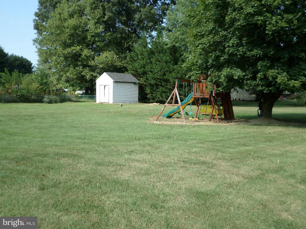 2520 Neudecker Road Westminster, MD 21157 - Photo 21 of 27 a backyard of a house with childrens swings and slides