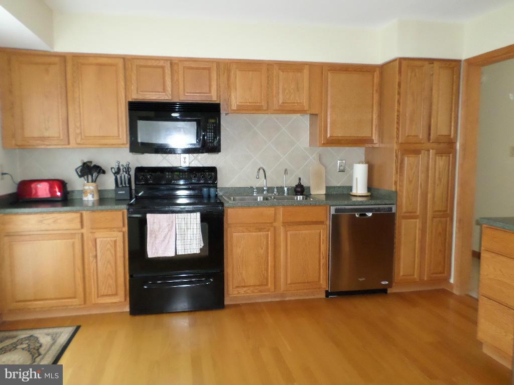 2520 Neudecker Road Westminster, MD 21157 - Photo 7 of 27 a kitchen with granite countertop a refrigerator stove and sink