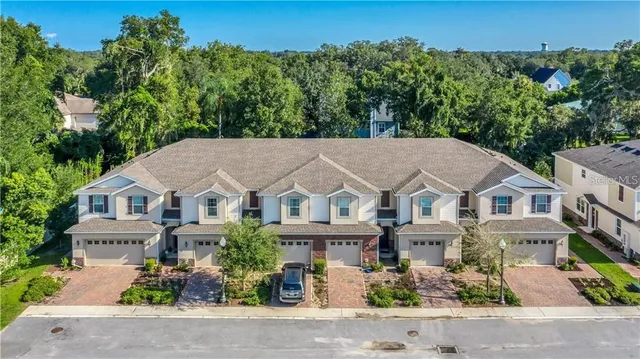 a bathroom with a double vanity sink toilet mirror and bathtub