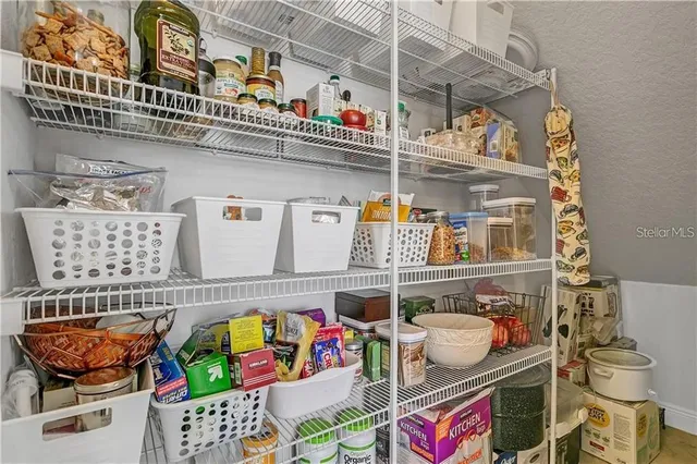 a view of a patio with table and chairs potted plants