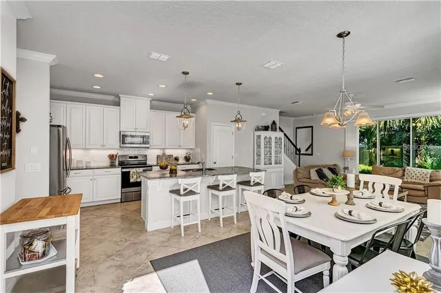 a utility room with stainless steel appliances lots of clutter