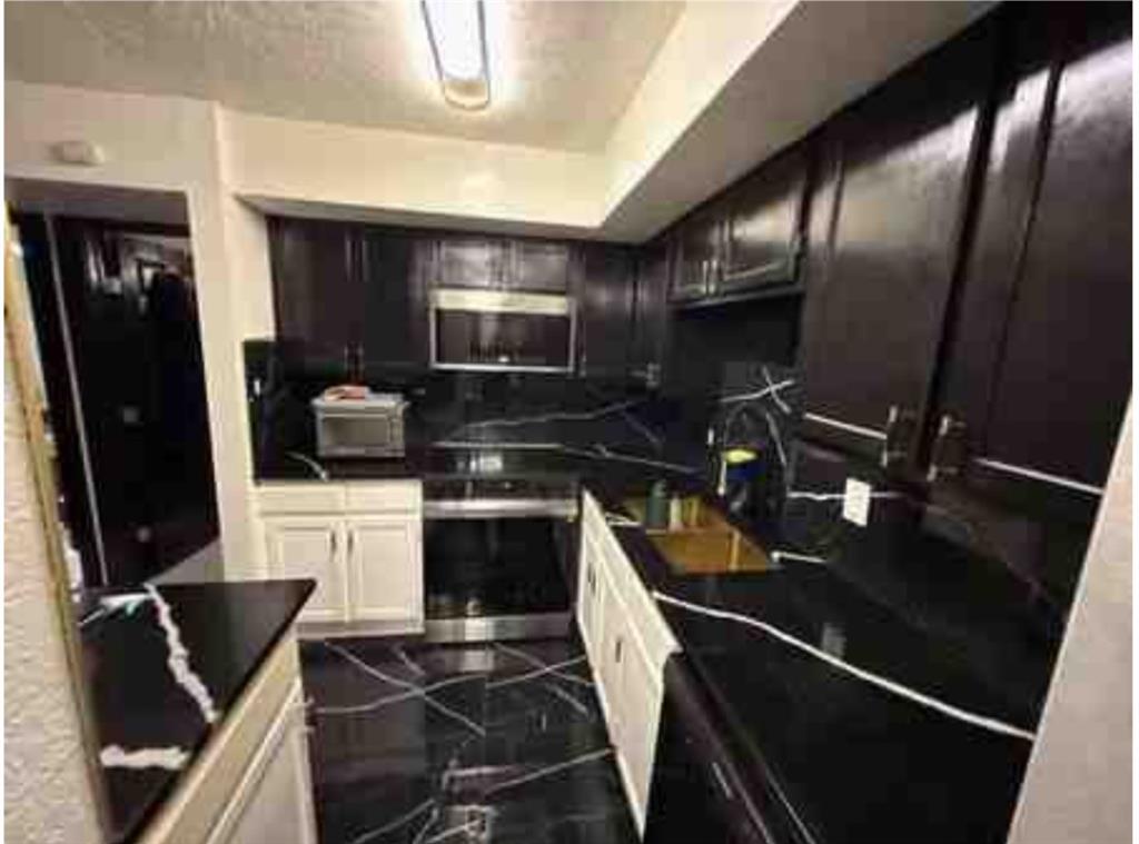 a kitchen with a sink appliances and cabinets