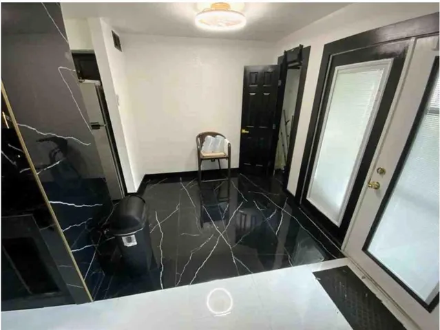 a view of a hallway with furniture and front door