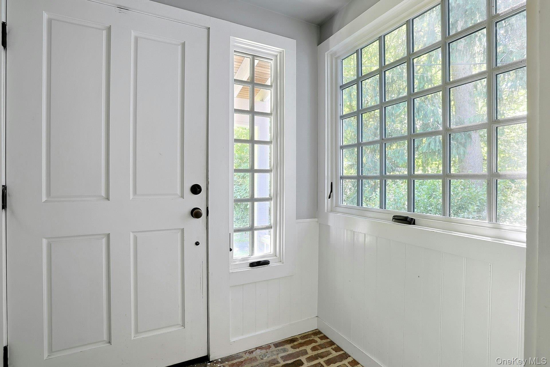 65 Douglas Road Chappaqua, NY 10514 - Photo 5 of 41 A light-filled entry creates a warm and inviting welcome, leading effortlessly into the living room and setting the tone for the home’s bright, comfortable interiors.