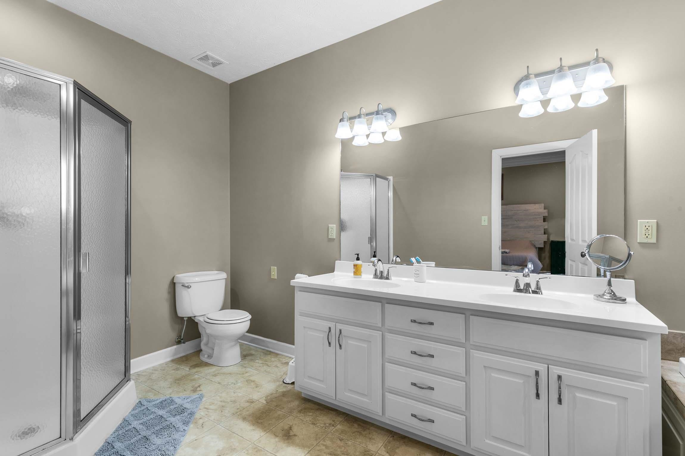 335 Booth Loop Henderson, TN 38340 - Photo 11 of 20 a bathroom with double sink a toilet and a mirror