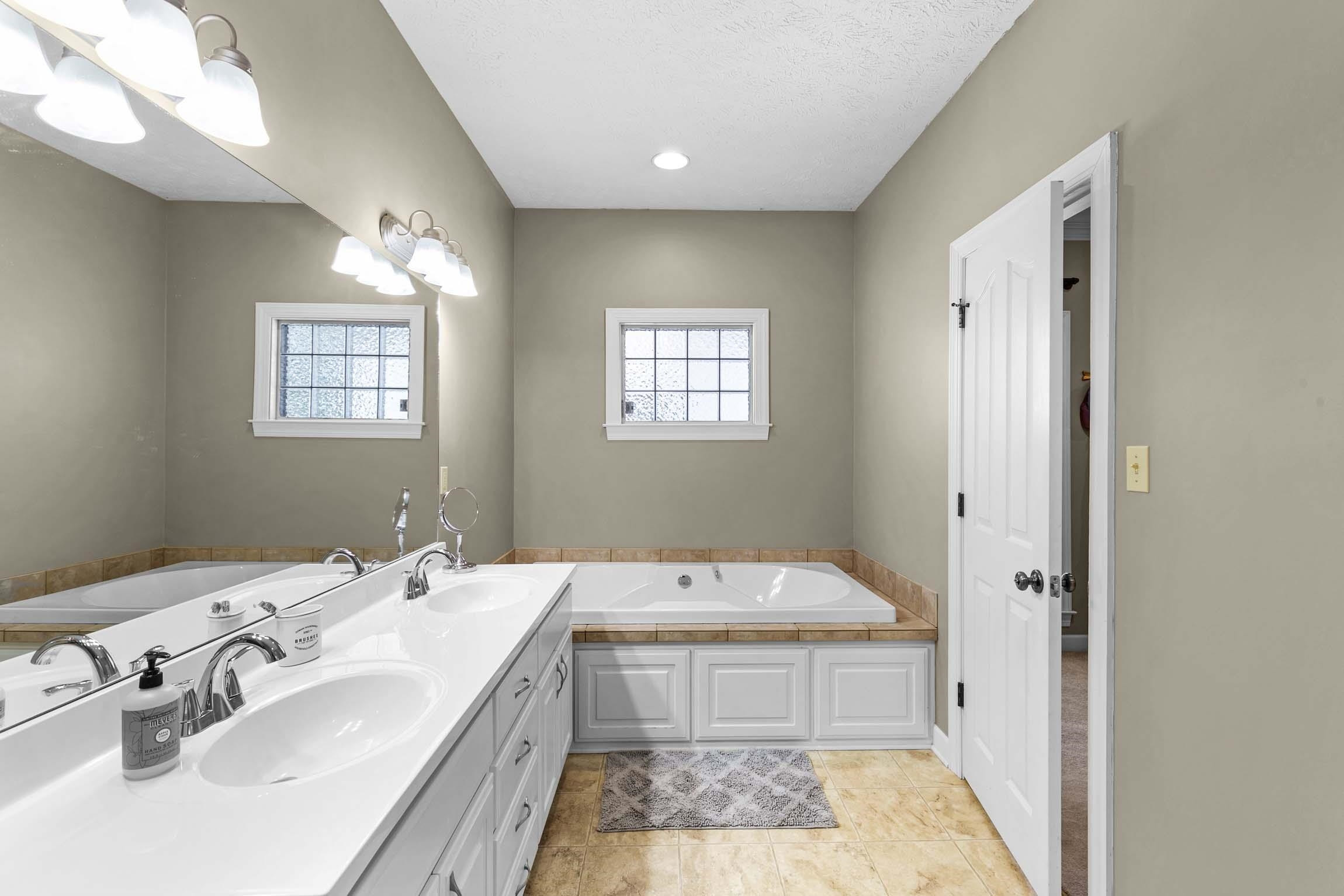 335 Booth Loop Henderson, TN 38340 - Photo 12 of 20 a spacious bathroom with a double vanity sink and a mirror