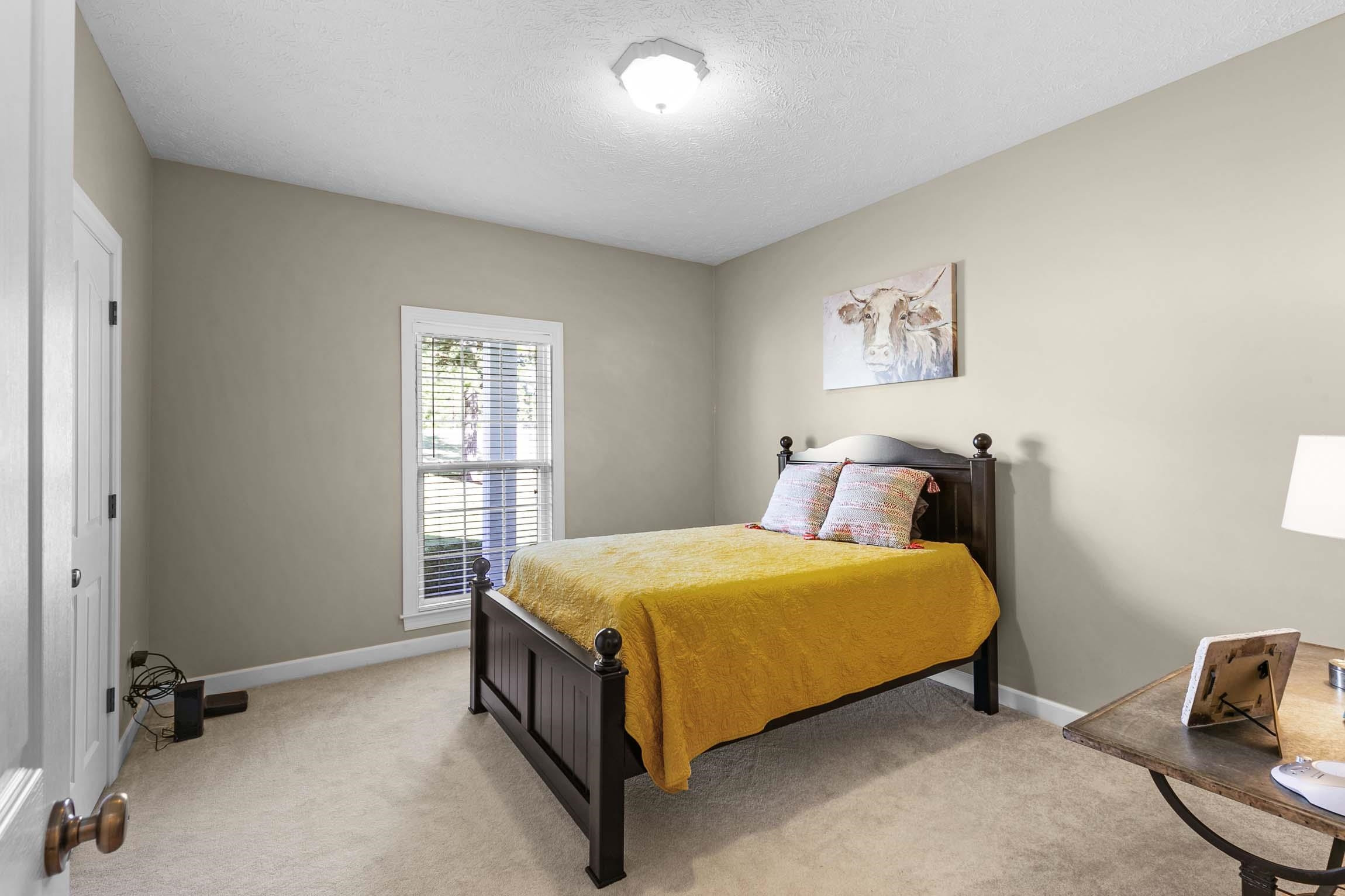 335 Booth Loop Henderson, TN 38340 - Photo 13 of 20 a bed sitting in a bedroom next to a window
