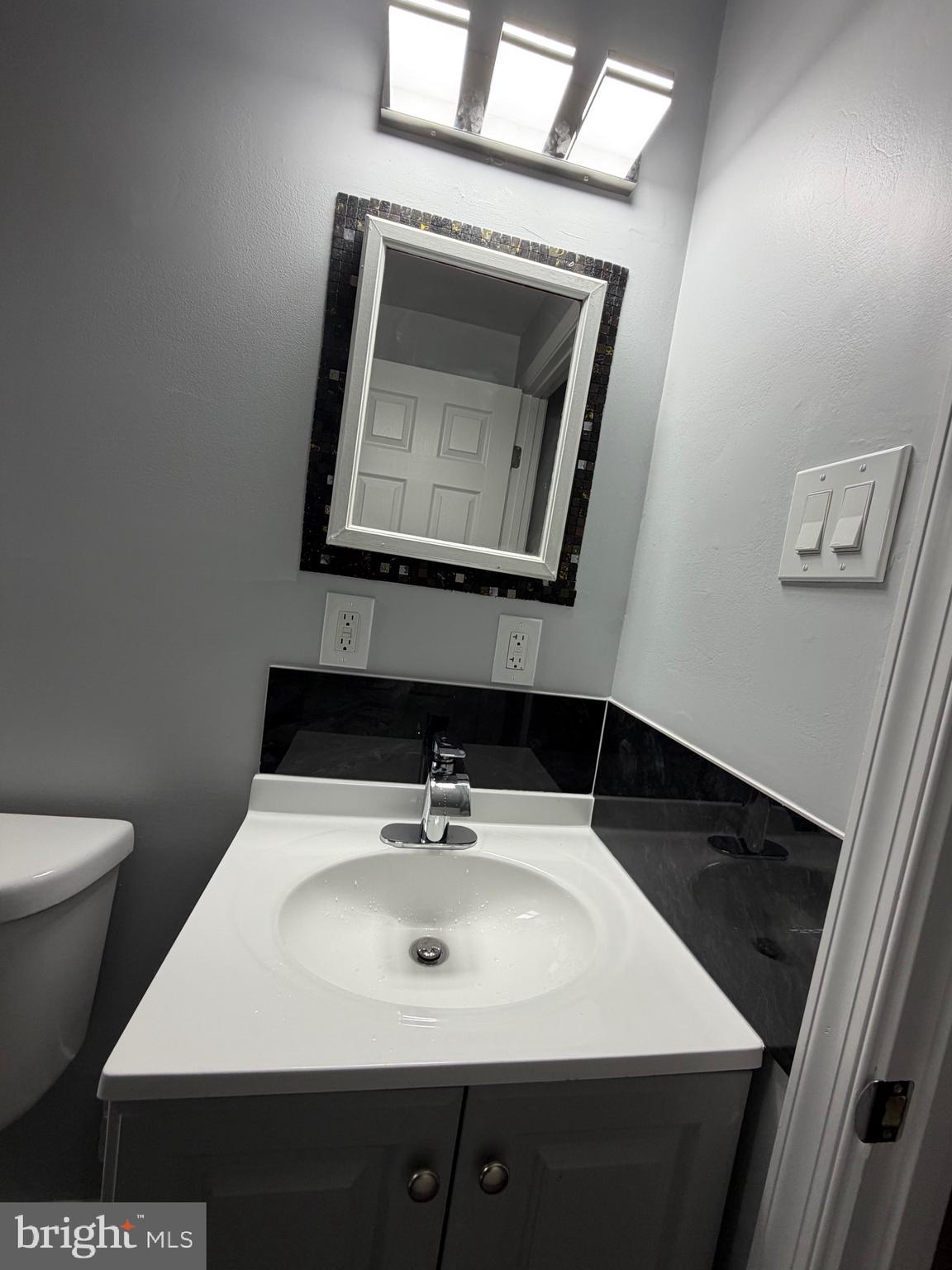 2004 Kelmore Road Baltimore, MD 21222 - Photo 18 of 39 a bathroom with a toilet sink and mirror