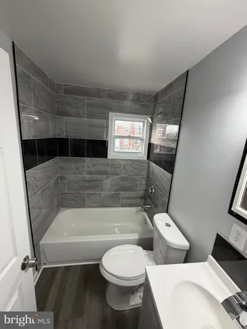 a bathroom with a toilet a sink and bathtub