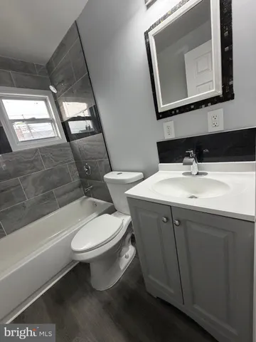 a bathroom with a toilet a sink and bathtub