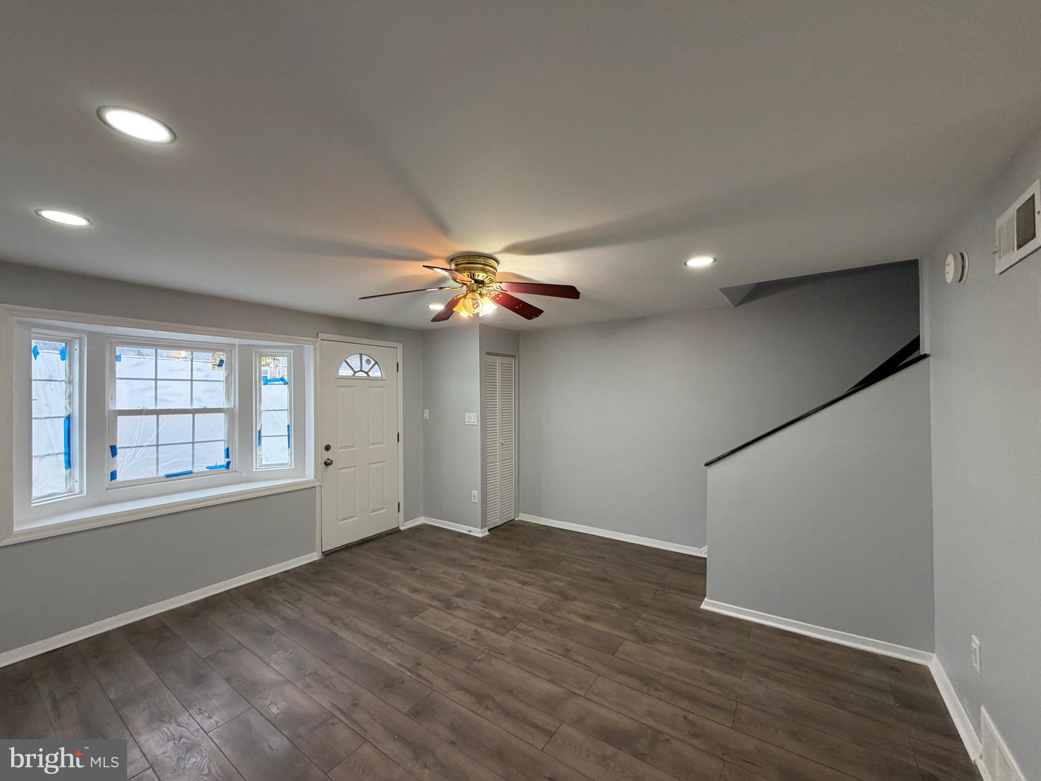2004 Kelmore Road Baltimore, MD 21222 - Photo 29 of 39 an empty room with wooden floor fan and windows