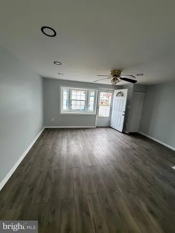 a view of hallway with wooden floor