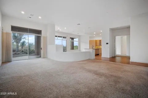 a view of a hallway with wooden floor and a large window