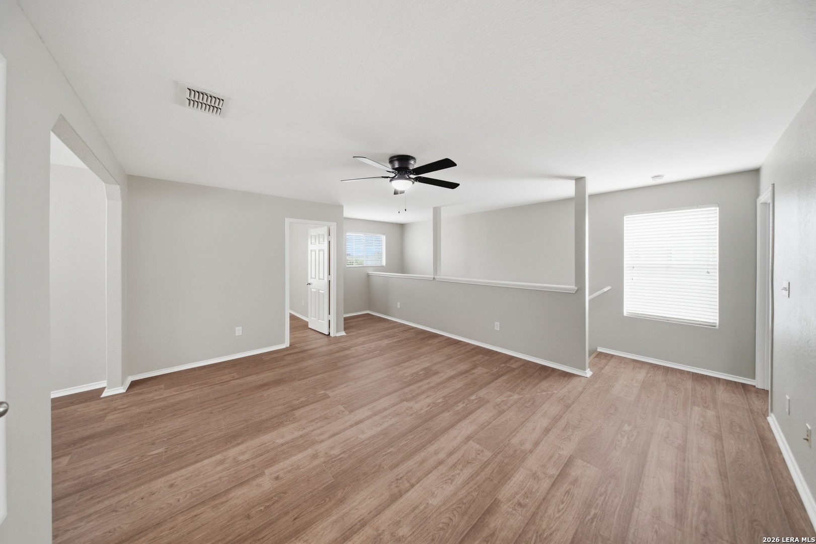 403 Walnut Crest Schertz, TX 78154 - Photo 15 of 30 a view of an empty room with wooden floor and a window