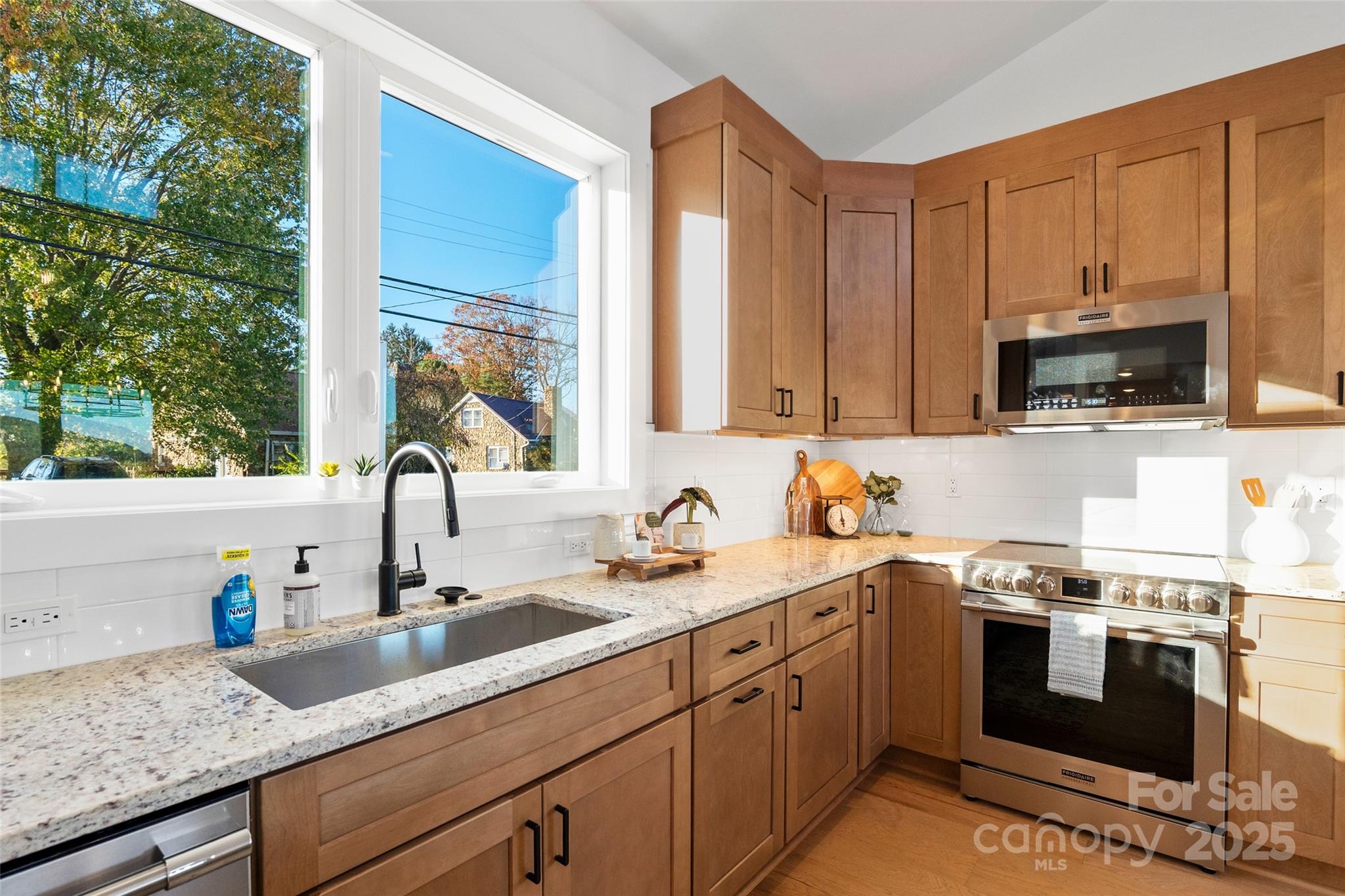 872 Newfound Road Canton, NC 28716 - Photo 12 of 44 a kitchen with stainless steel appliances granite countertop a sink a stove and a microwave