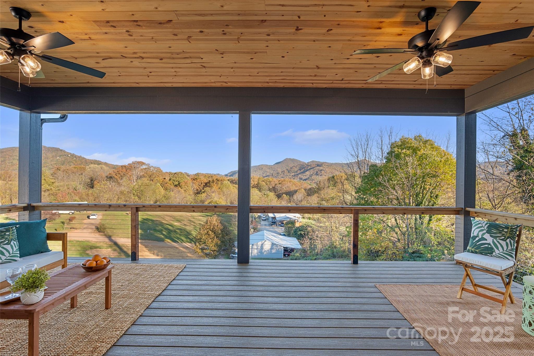 872 Newfound Road Canton, NC 28716 - Photo 15 of 44 a view of a balcony with wooden floor and outdoor seating
