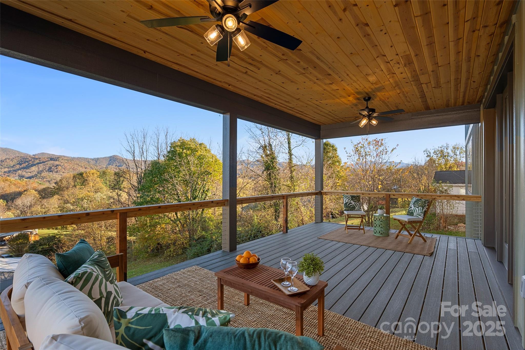 872 Newfound Road Canton, NC 28716 - Photo 16 of 44 a view of a balcony with furniture and wooden floor