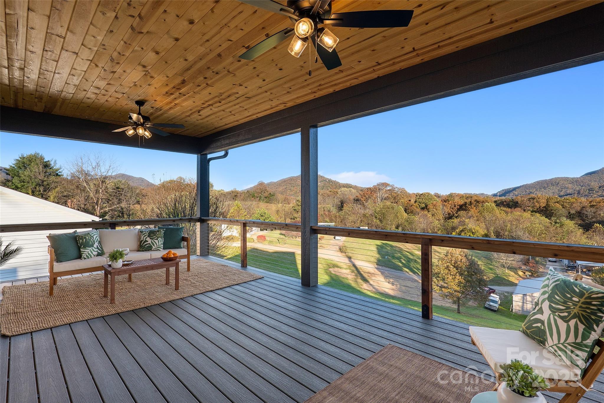 872 Newfound Road Canton, NC 28716 - Photo 17 of 44 a view of a balcony with couch and wooden floor