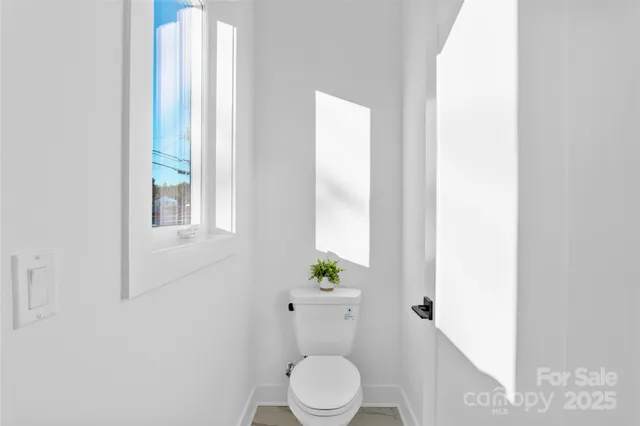 a white toilet sitting next to a bathroom sink