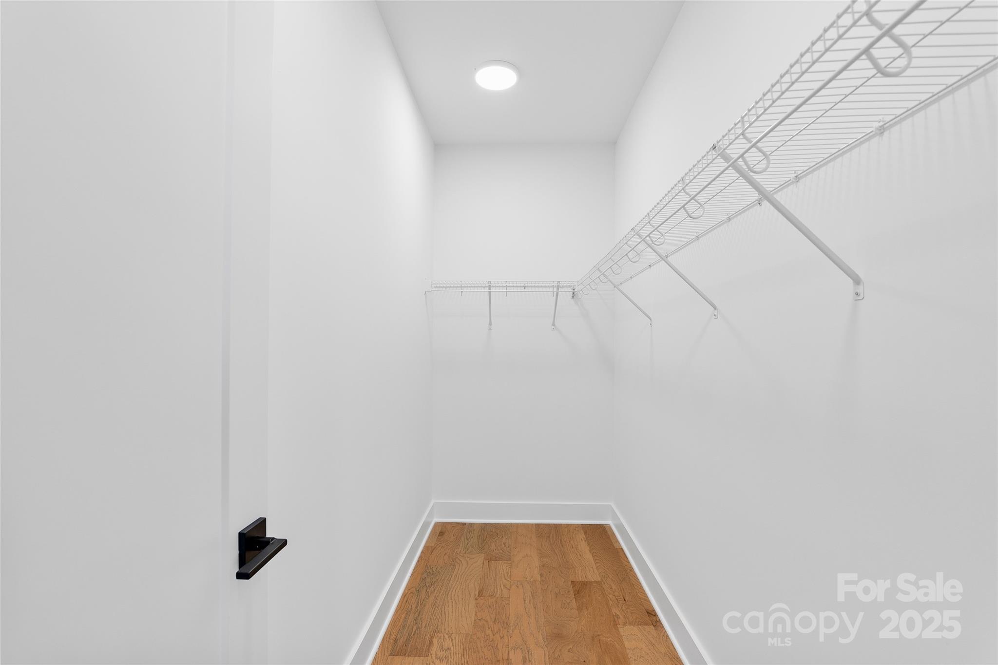 872 Newfound Road Canton, NC 28716 - Photo 31 of 44 a view of a livingroom with wooden floor and a ceiling fan