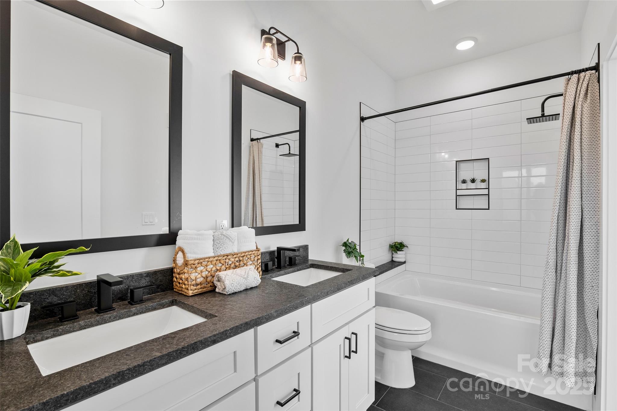 872 Newfound Road Canton, NC 28716 - Photo 32 of 44 a bathroom with a granite countertop sink a toilet and a bathtub