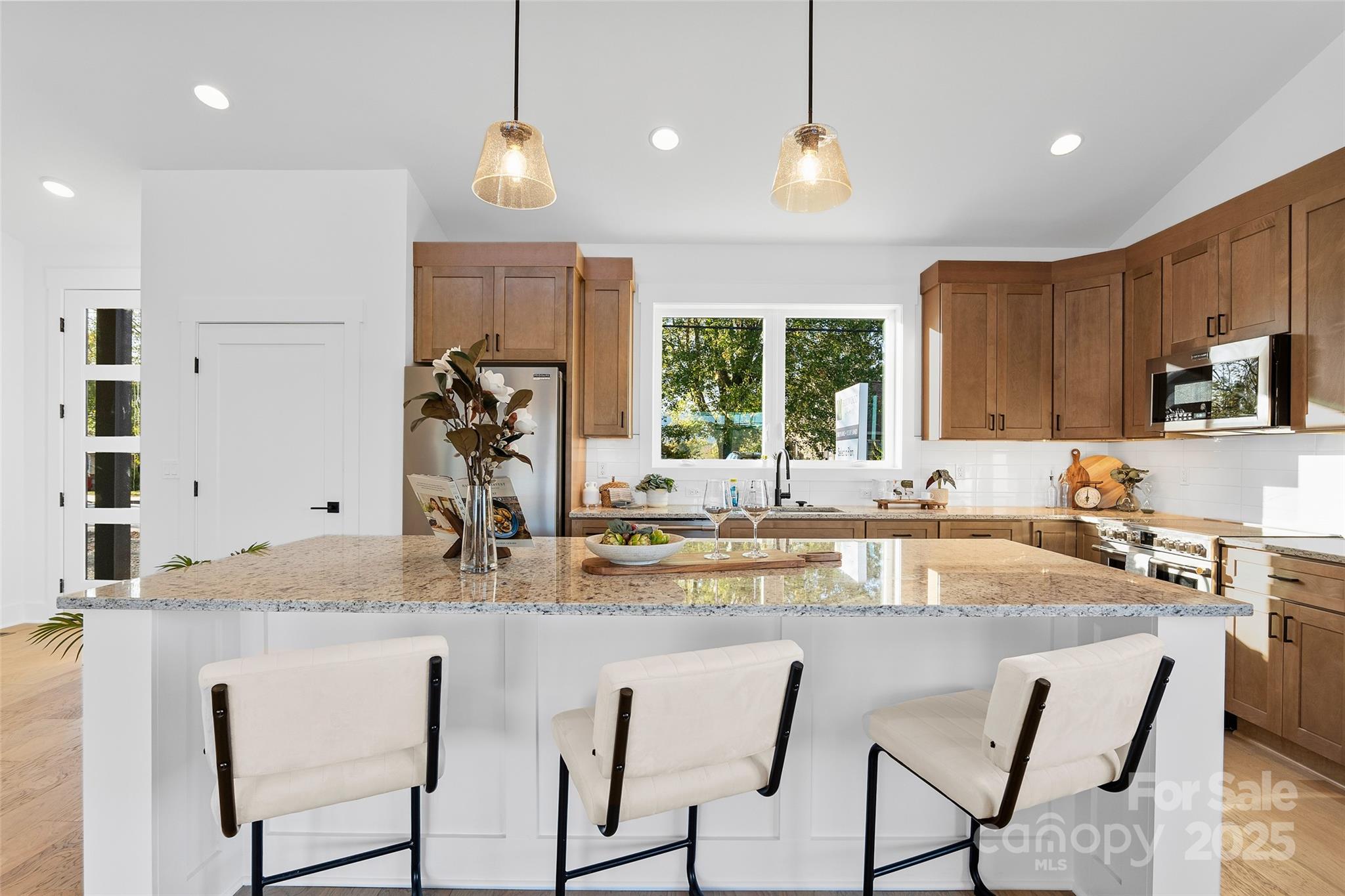 872 Newfound Road Canton, NC 28716 - Photo 9 of 44 a kitchen with kitchen island granite countertop a table chairs sink and microwave