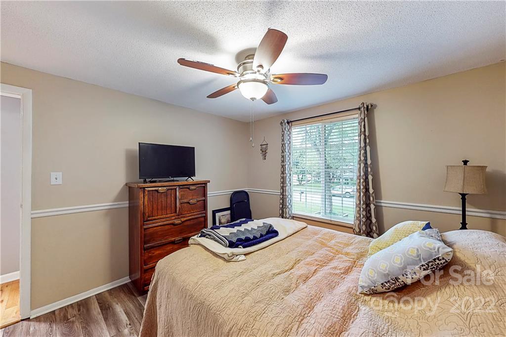 12118 Mapleton Road Charlotte, NC 28273 - Photo 16 of 48 a bedroom with a bed and a tv