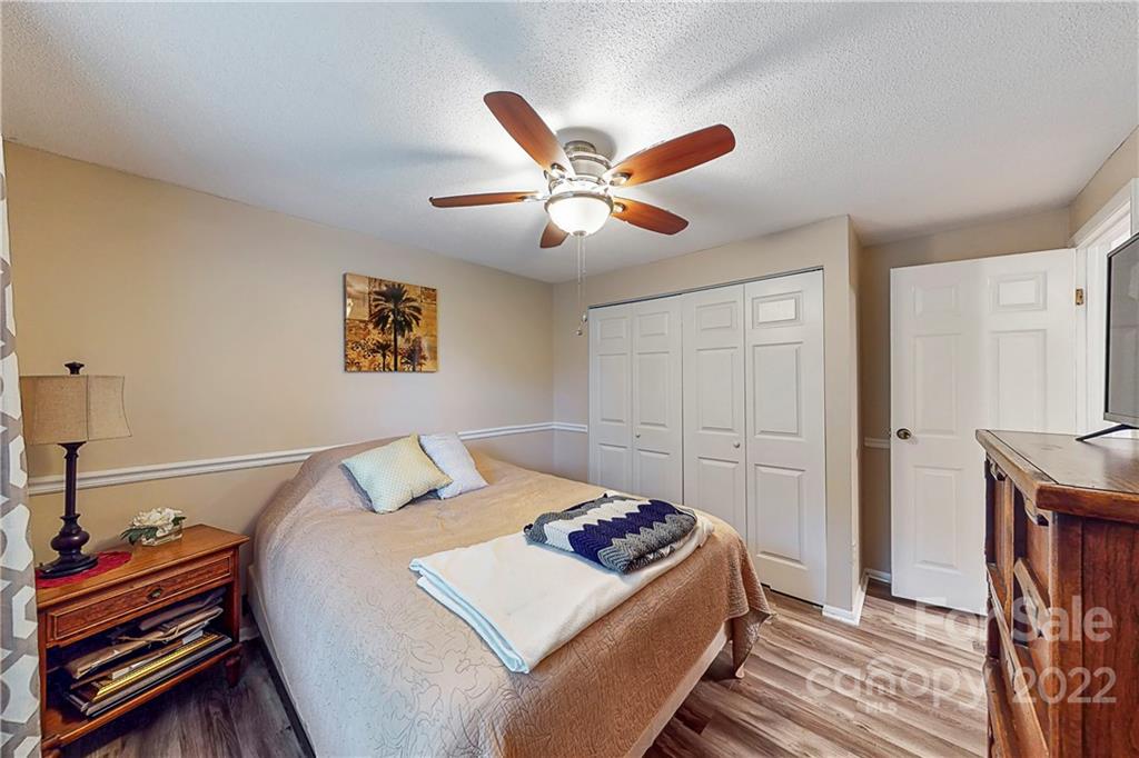 12118 Mapleton Road Charlotte, NC 28273 - Photo 17 of 48 a bedroom with a bed and a chandelier