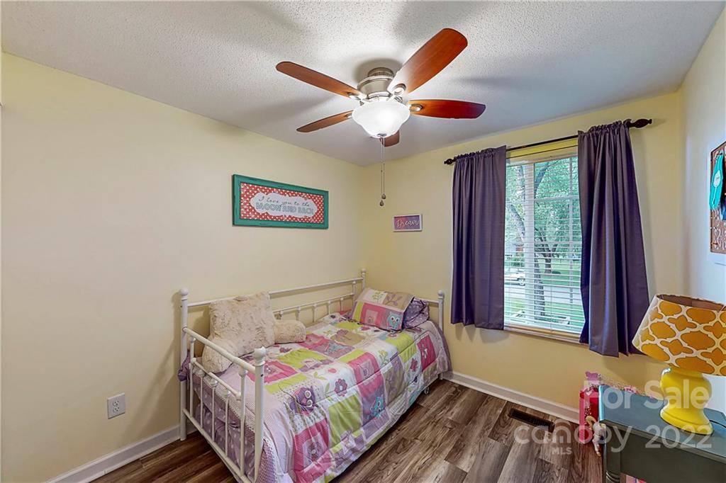 12118 Mapleton Road Charlotte, NC 28273 - Photo 18 of 48 a bedroom with a bed and a chandelier