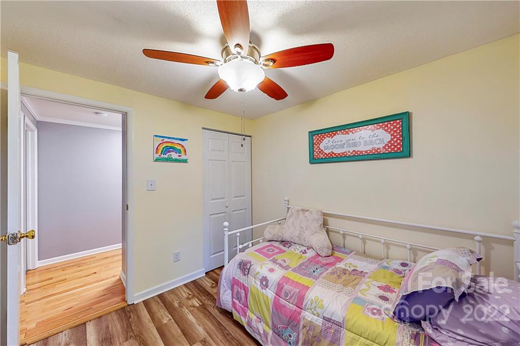 12118 Mapleton Road Charlotte, NC 28273 - Photo 19 of 48 a bedroom with a bed and a chandelier