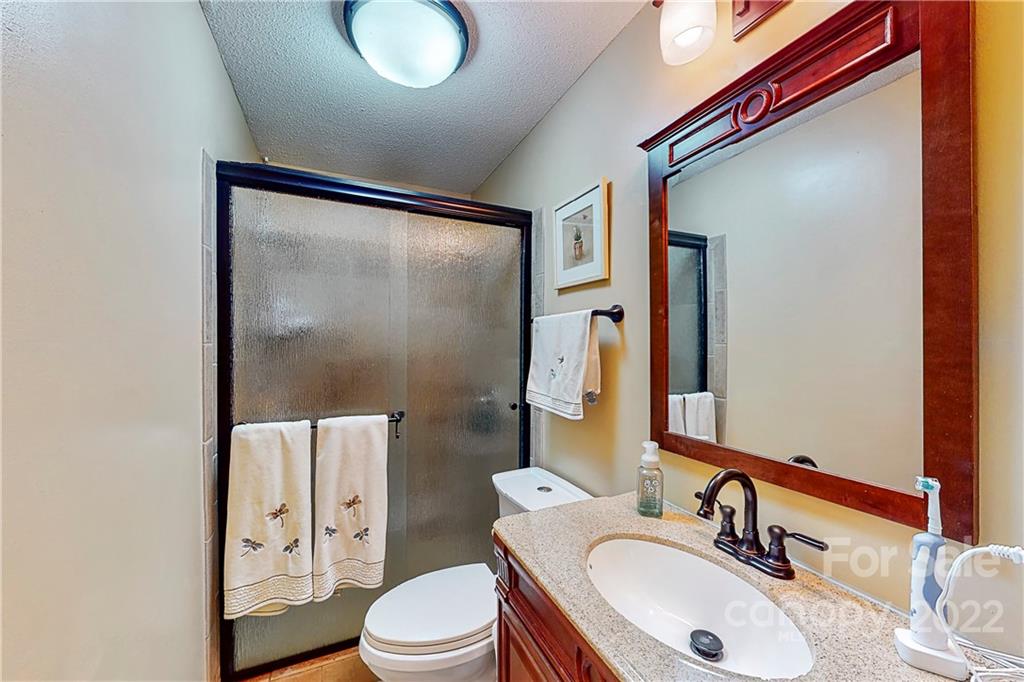 12118 Mapleton Road Charlotte, NC 28273 - Photo 20 of 48 a bathroom with a sink vanity mirror and toilet