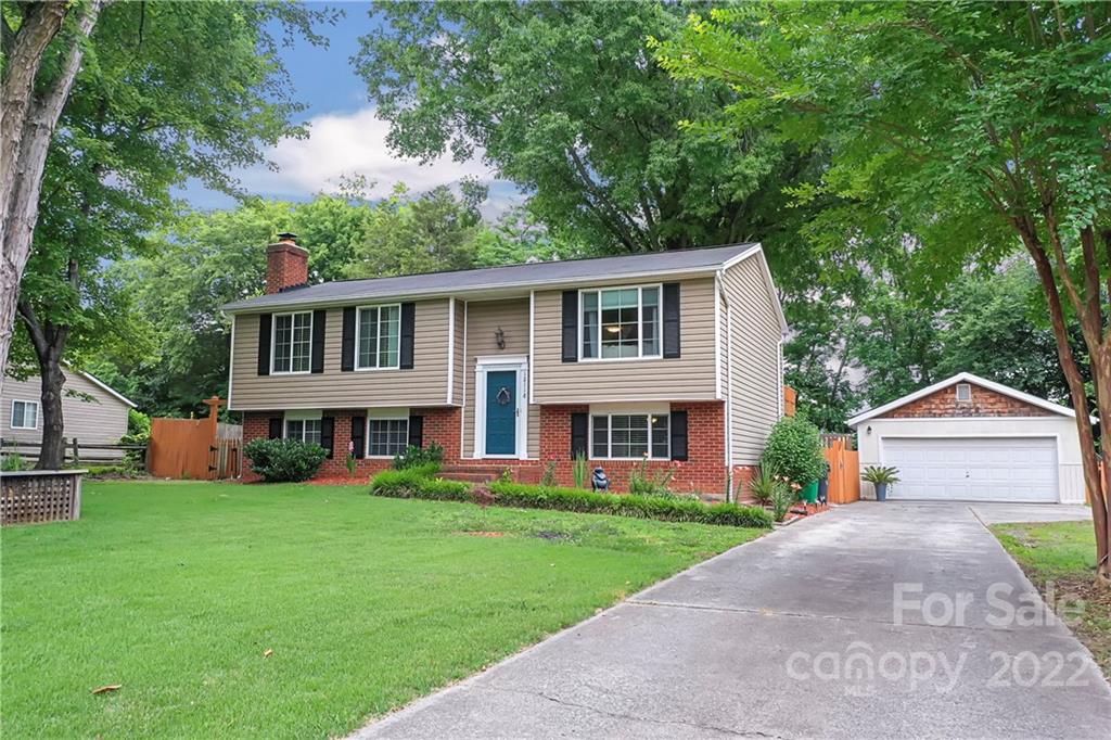 12118 Mapleton Road Charlotte, NC 28273 - Photo 2 of 48 a front view of a house with a yard and trees