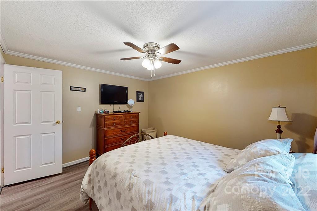 12118 Mapleton Road Charlotte, NC 28273 - Photo 22 of 48 a bedroom with a bed and a flat screen tv