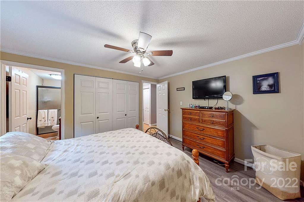12118 Mapleton Road Charlotte, NC 28273 - Photo 24 of 48 a bedroom with a bed and a flat screen tv