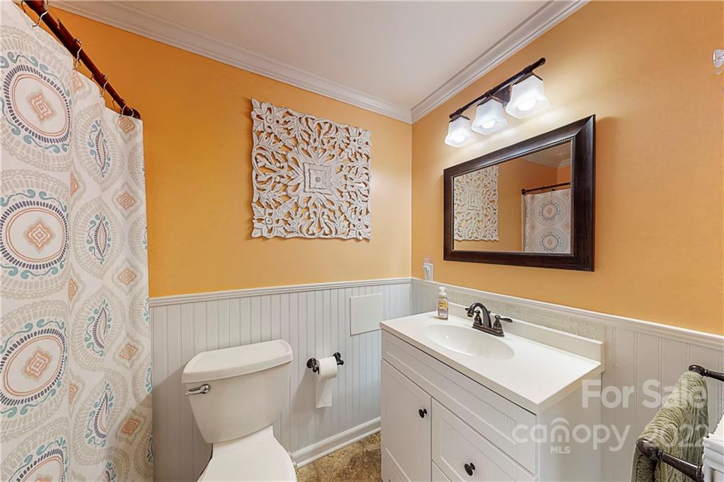 12118 Mapleton Road Charlotte, NC 28273 - Photo 25 of 48 a bathroom with a toilet sink and mirror