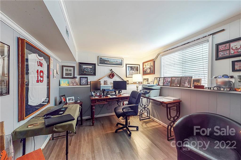 12118 Mapleton Road Charlotte, NC 28273 - Photo 32 of 48 a work room with furniture and a wooden floor