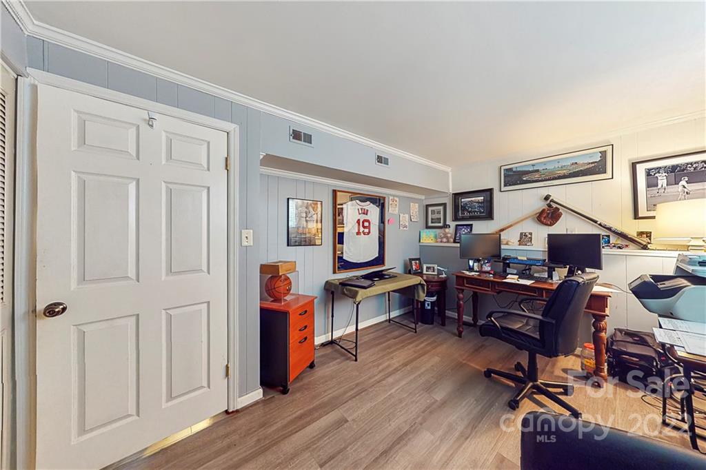 12118 Mapleton Road Charlotte, NC 28273 - Photo 33 of 48 a workspace with furniture and wooden floor