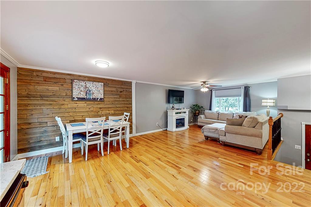 12118 Mapleton Road Charlotte, NC 28273 - Photo 7 of 48 a living room with furniture wooden floor and kitchen view