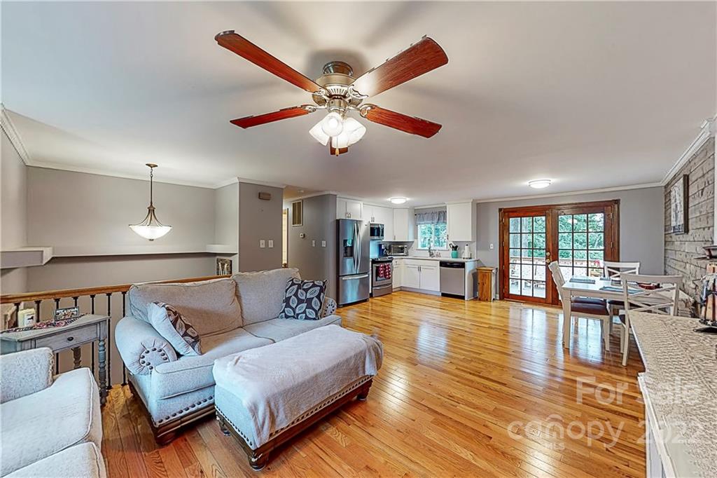12118 Mapleton Road Charlotte, NC 28273 - Photo 8 of 48 a living room with furniture ceiling fan and a large window