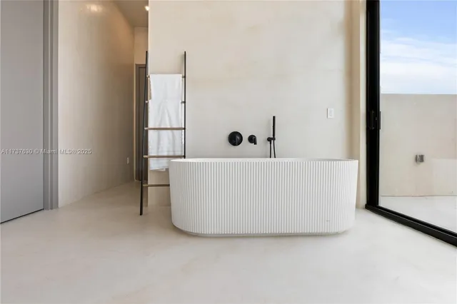 a white tub sitting next to a window