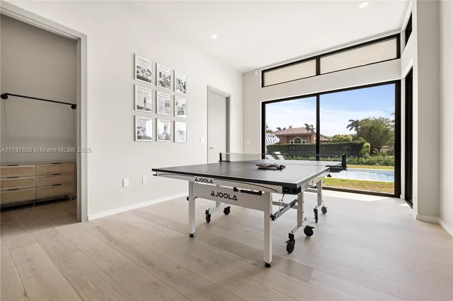 a view of a room with gym equipment and floor to ceiling window